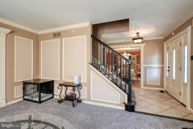 a view of a livingroom with furniture and staircase