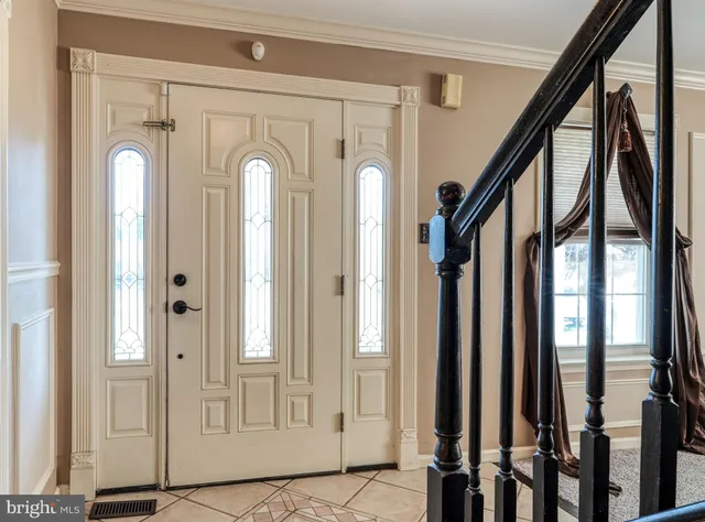 a front view of a house with wooden floor and windows