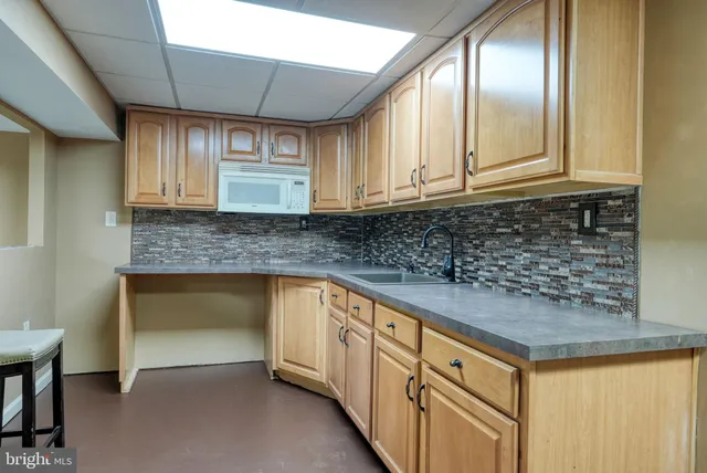a kitchen with granite countertop white cabinets and a sink
