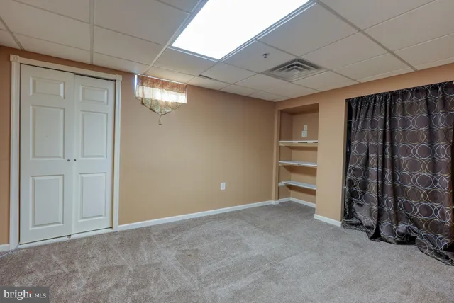 a view of an empty room with a fireplace