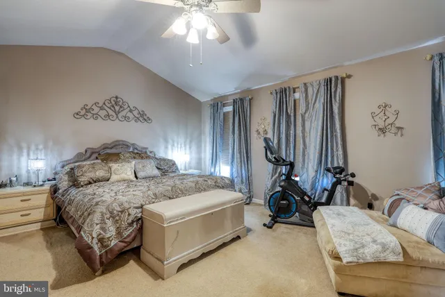 a bedroom with bed couch and window