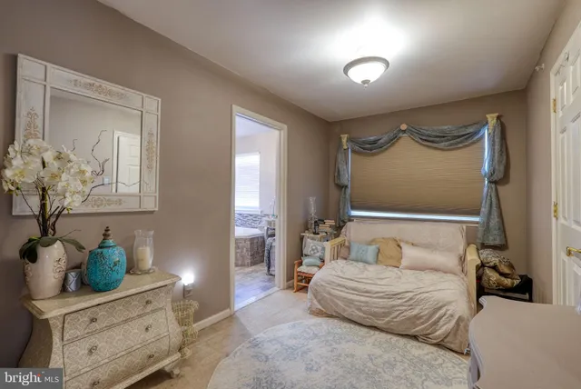 a bedroom with a bed and a potted plant