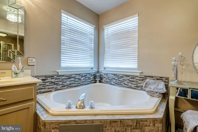 a bath tub sitting in a bathroom next to a sink