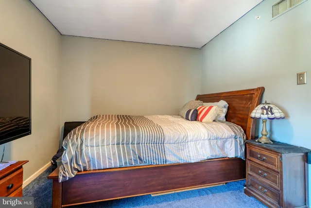 a bedroom with a bed and a tv