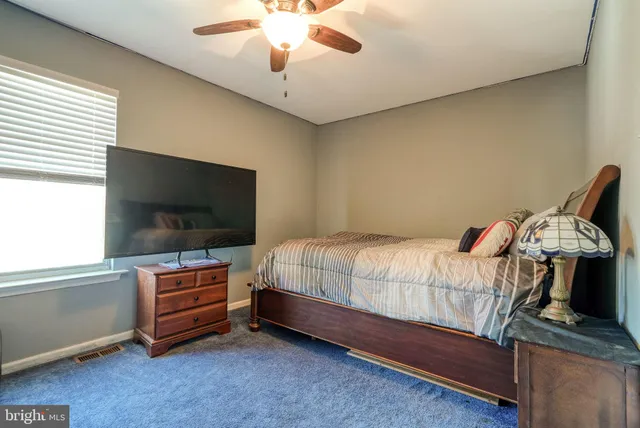 a bedroom with bed and flat screen tv