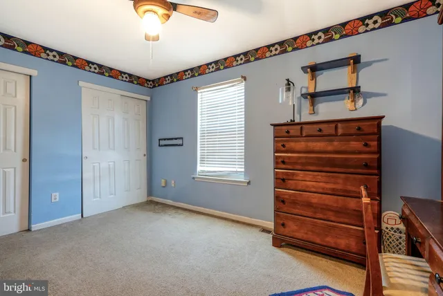 a view of room with stairs and a ceiling fan