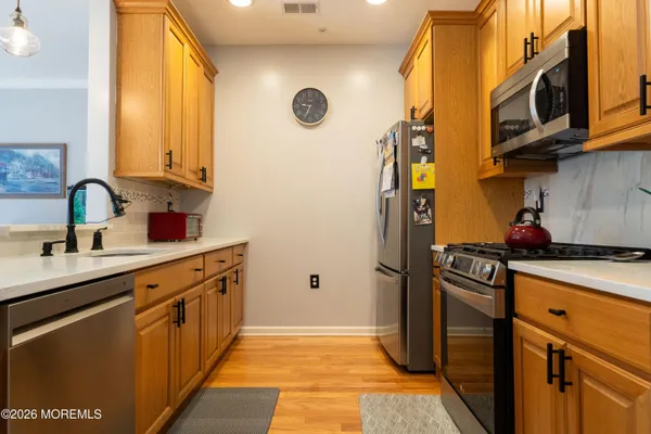 a kitchen with stainless steel appliances granite countertop a sink and cabinets