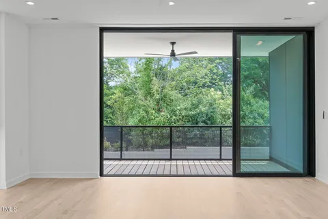a view of a kitchen with a sink and a large window