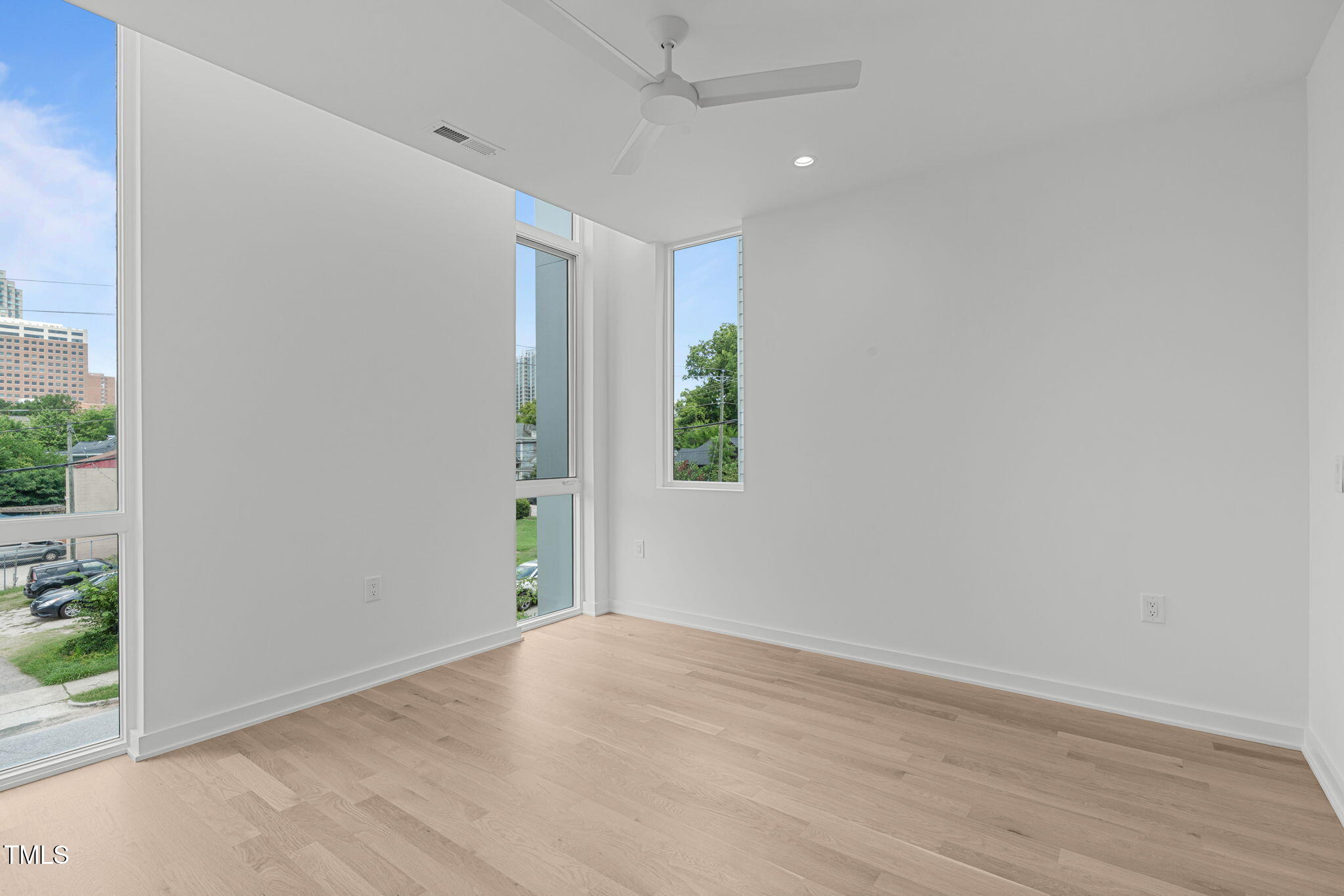 511 South Bloodworth Street, Unit 101 Raleigh, NC 27601 - Photo 19 of 51 an empty room with wooden floor and windows