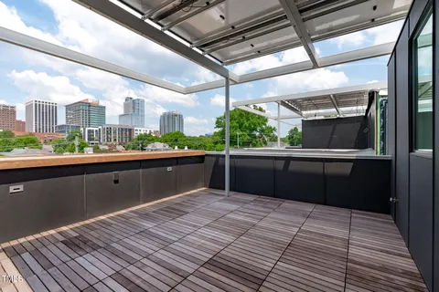 a kitchen with stainless steel appliances kitchen island granite countertop a refrigerator and window