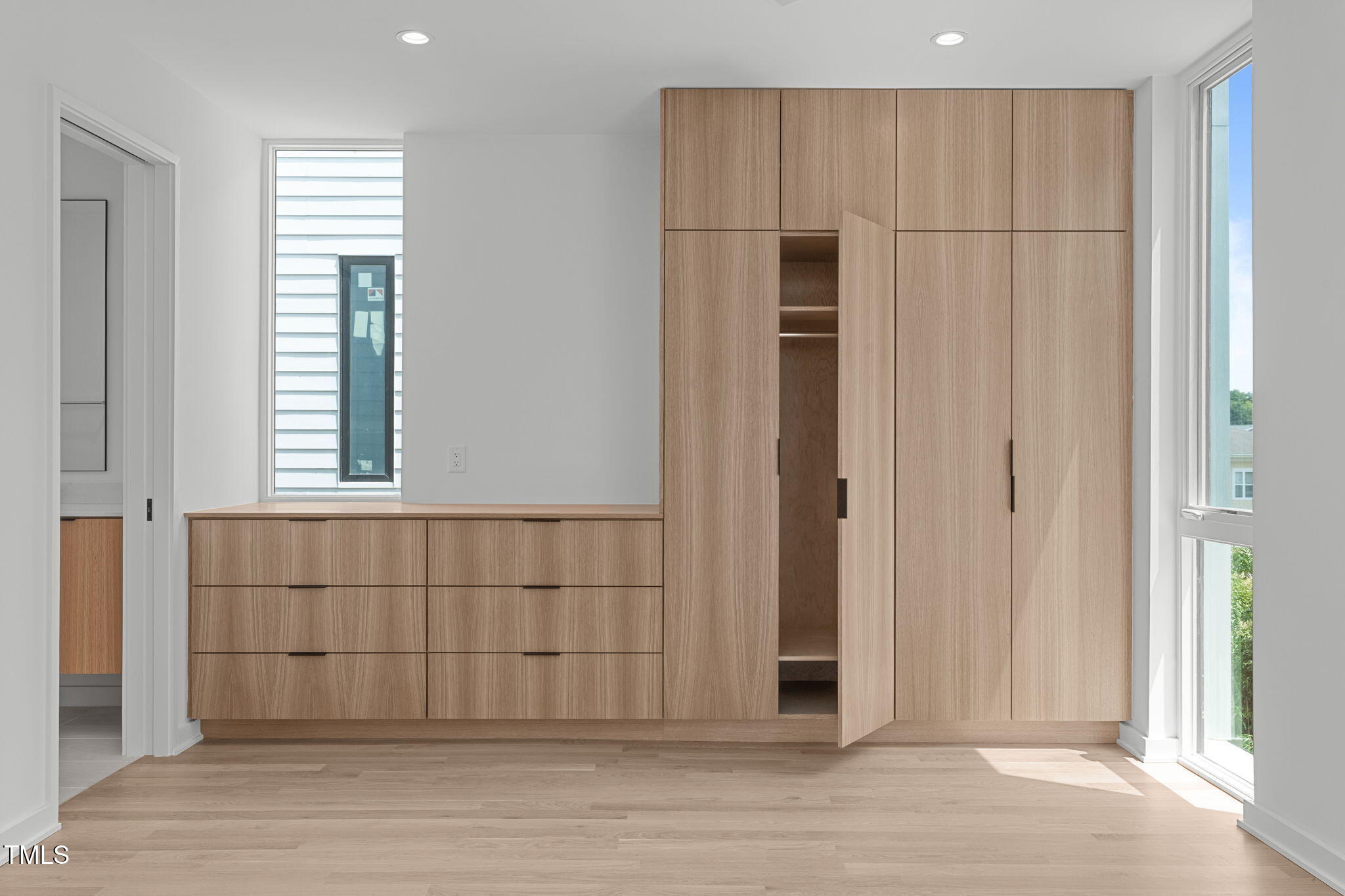 511 South Bloodworth Street, Unit 101 Raleigh, NC 27601 - Photo 23 of 51 an empty room with wooden floor and windows