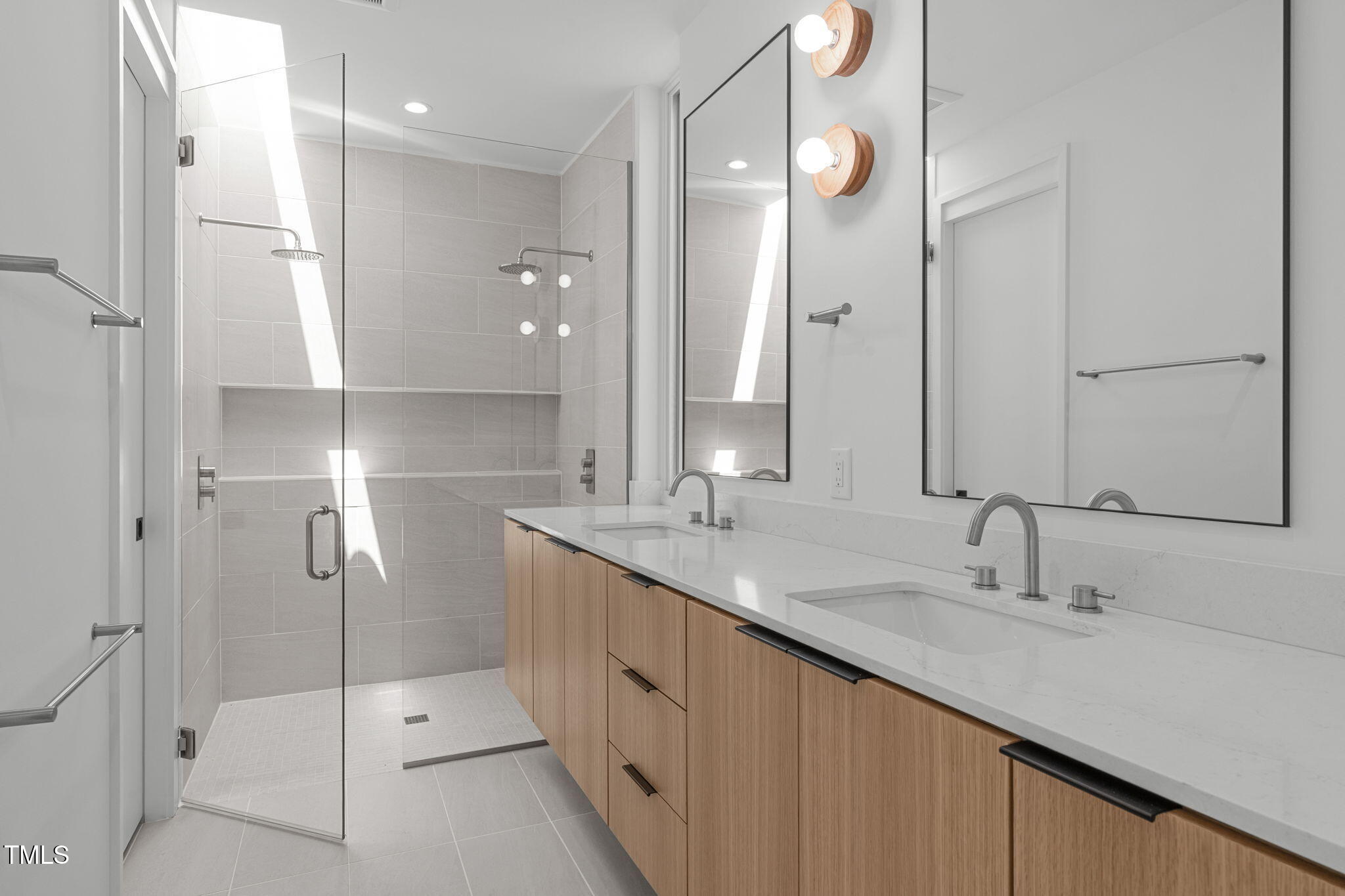 511 South Bloodworth Street, Unit 101 Raleigh, NC 27601 - Photo 25 of 51 a bathroom with a double vanity sink mirror and double