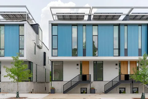 a view of a house with a yard from a balcony