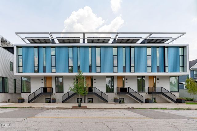 a front view of a house with a yard outdoor seating and entertaining space