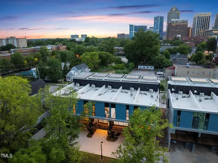 a view of a patio with a table and chairs under an umbrella
