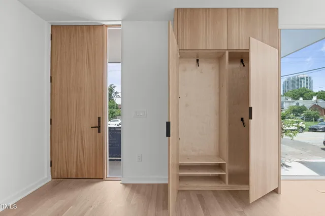 a view of walk in closet with wooden floor