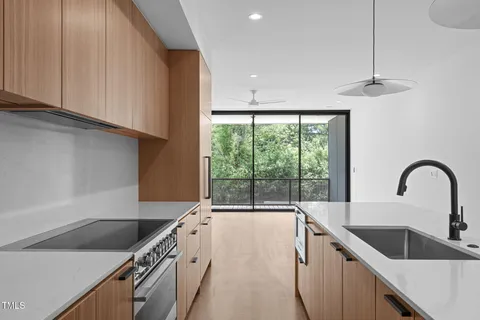 a kitchen with a sink a counter top space and stainless steel appliances