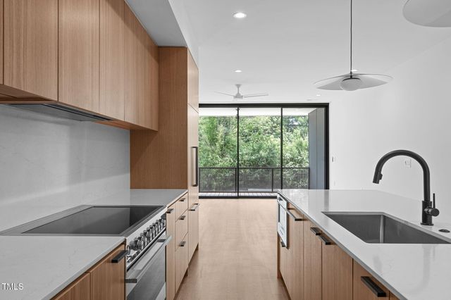 a kitchen with a sink a counter top space and stainless steel appliances
