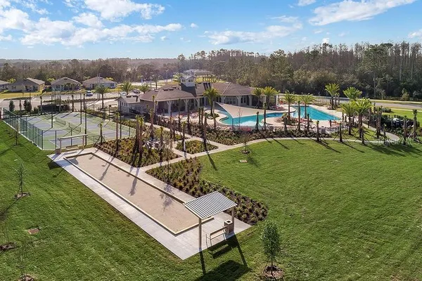 a view of backyard with swimming pool and sitting area