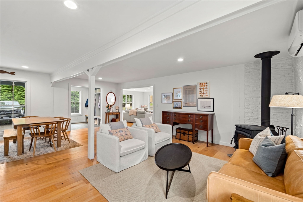 8 R Rolfe's Lane Newbury, MA 01951 - Photo 22 of 42 a living room with furniture a fireplace and kitchen view