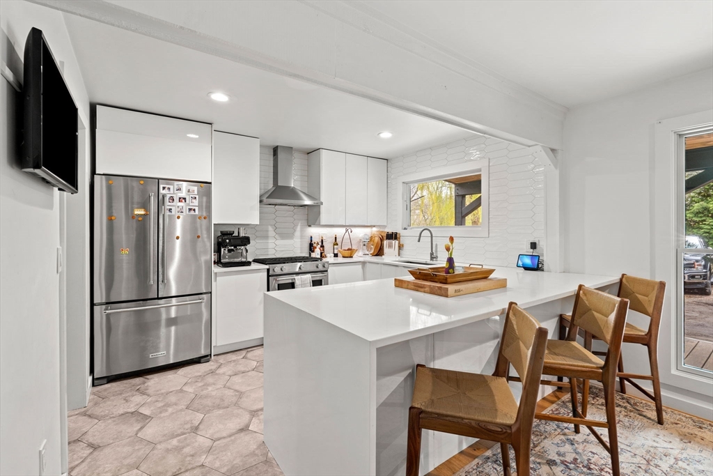 8 R Rolfe's Lane Newbury, MA 01951 - Photo 9 of 42 a kitchen with refrigerator and chairs