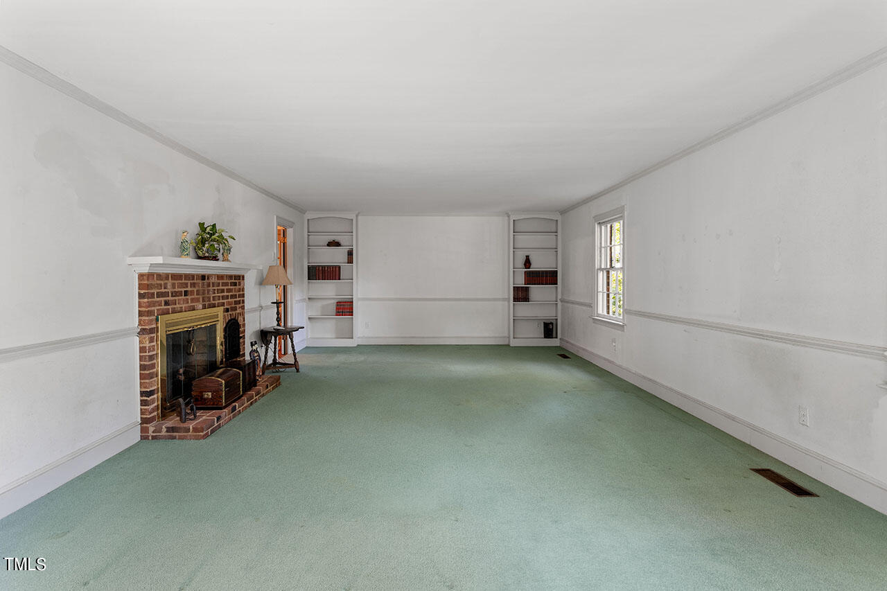 3408 Caldwell Drive Raleigh, NC 27607 - Photo 15 of 46 a view of empty room with fireplace and closet