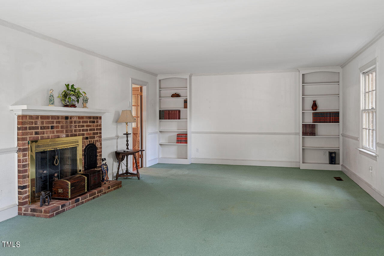 3408 Caldwell Drive Raleigh, NC 27607 - Photo 17 of 46 a view of empty room with fireplace and windows