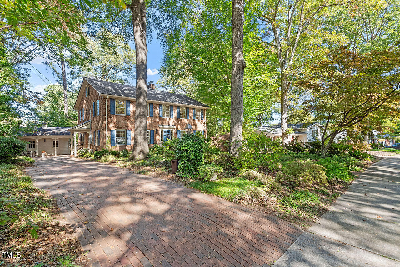 3408 Caldwell Drive Raleigh, NC 27607 - Photo 2 of 46 a view of a large house with large trees and plants
