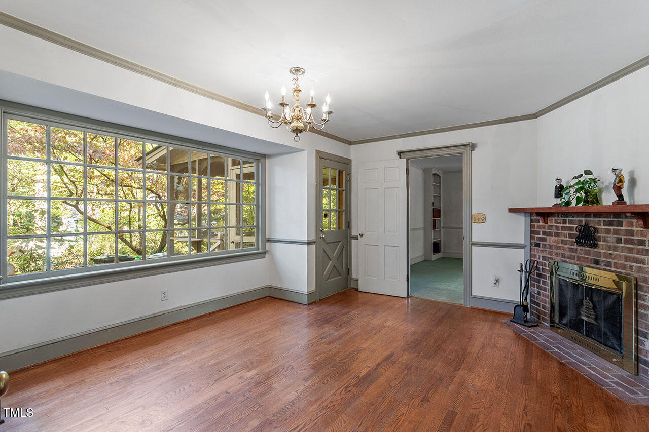3408 Caldwell Drive Raleigh, NC 27607 - Photo 24 of 46 wooden floor in an empty room with a fireplace