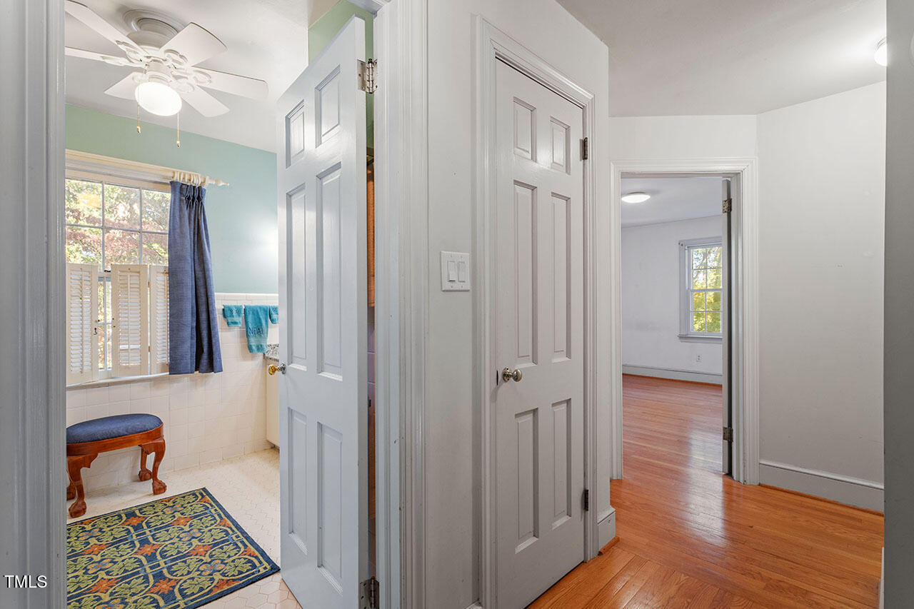 3408 Caldwell Drive Raleigh, NC 27607 - Photo 32 of 46 a view of a hallway to a livingroom with wooden floor and windows