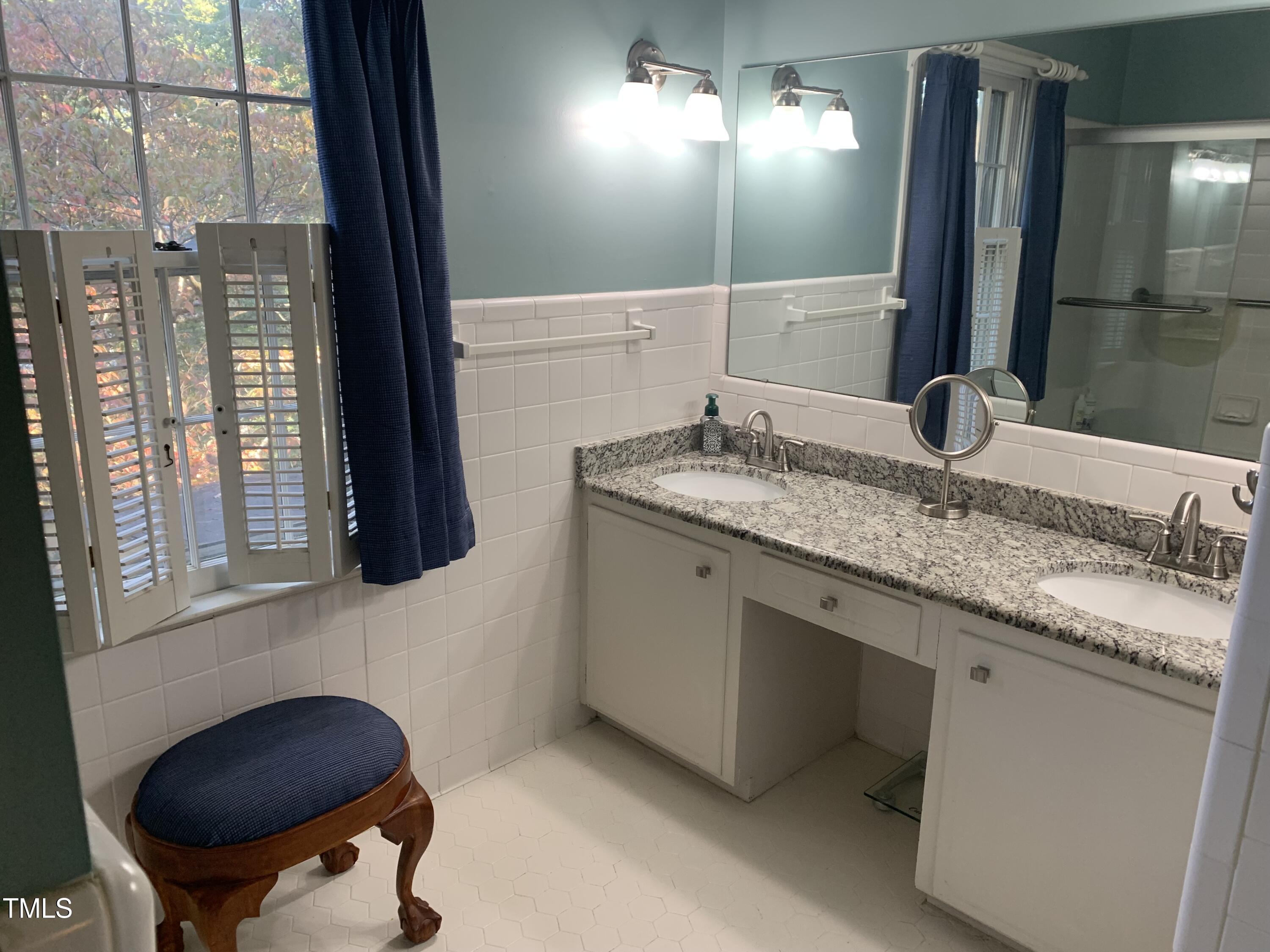 3408 Caldwell Drive Raleigh, NC 27607 - Photo 33 of 46 a bathroom with a granite countertop sink a toilet and mirror