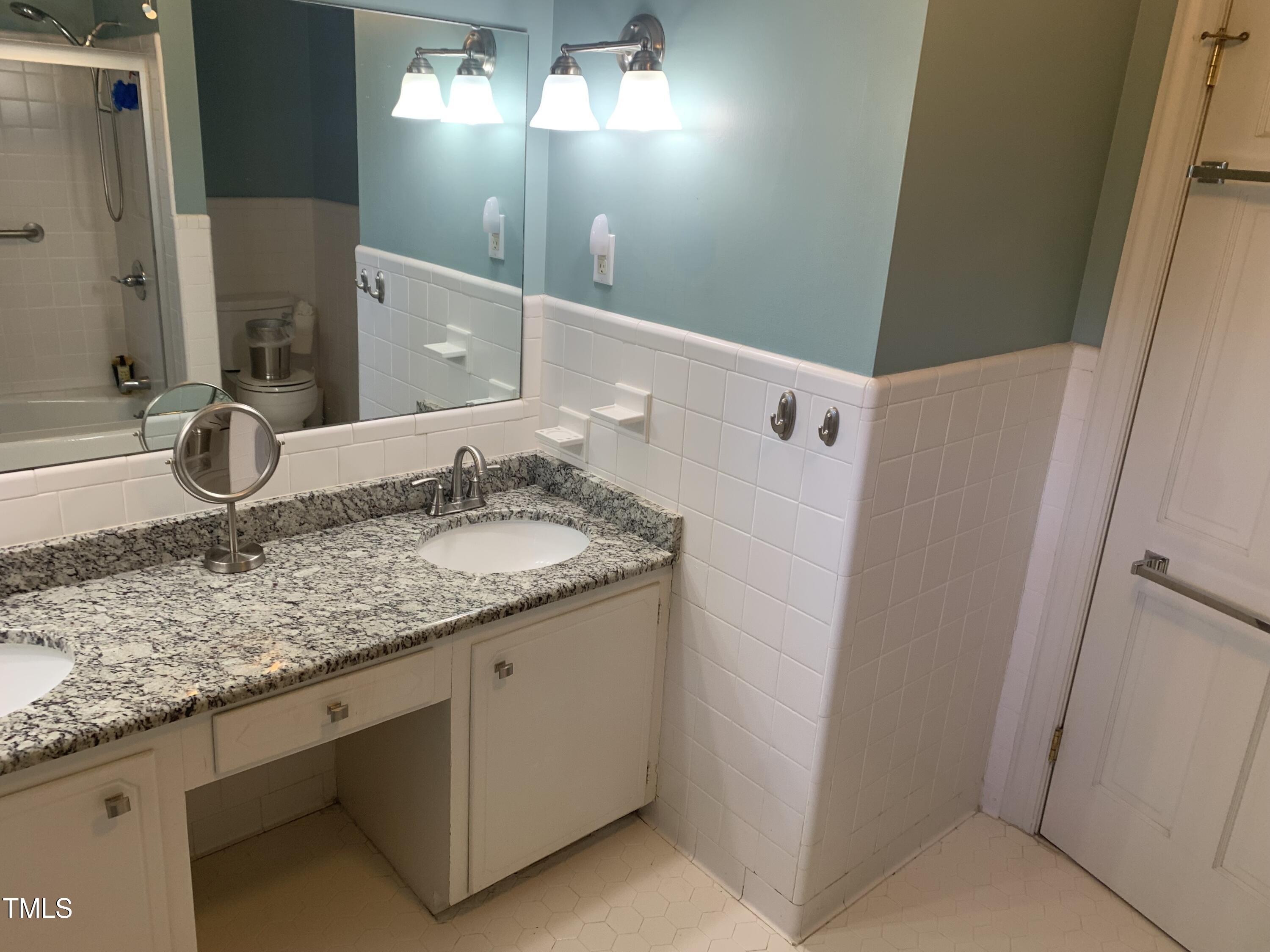 3408 Caldwell Drive Raleigh, NC 27607 - Photo 34 of 46 a bathroom with a granite countertop sink and a mirror