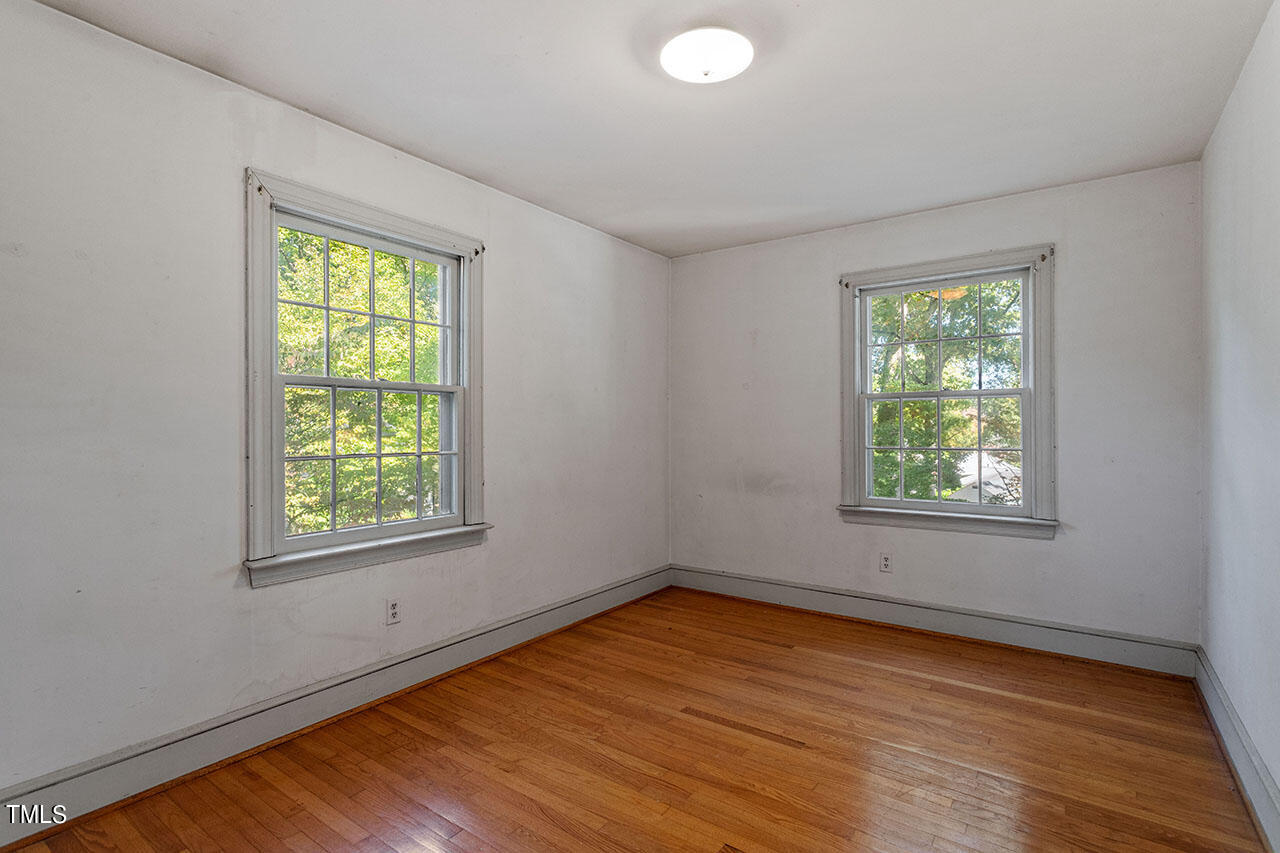 3408 Caldwell Drive Raleigh, NC 27607 - Photo 35 of 46 a view of an empty room with wooden floor and a window