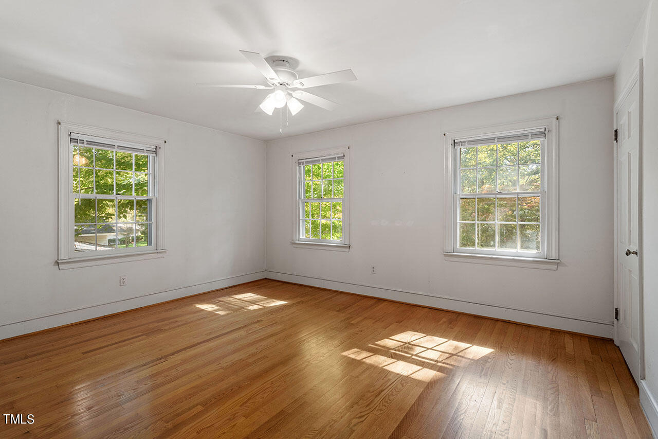 3408 Caldwell Drive Raleigh, NC 27607 - Photo 37 of 46 a view of an empty room with wooden floor and a window