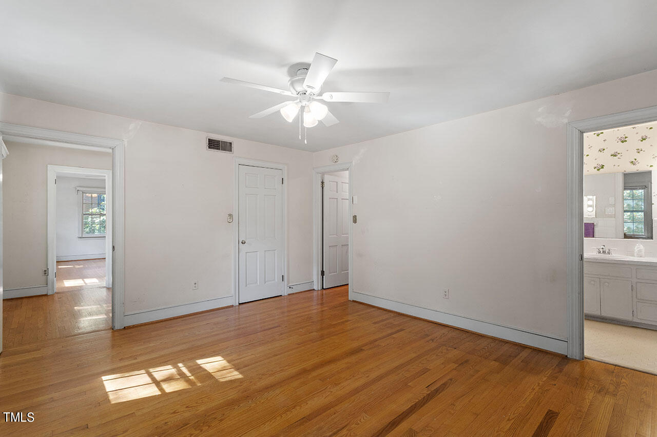 3408 Caldwell Drive Raleigh, NC 27607 - Photo 38 of 46 an empty room with wooden floor and windows
