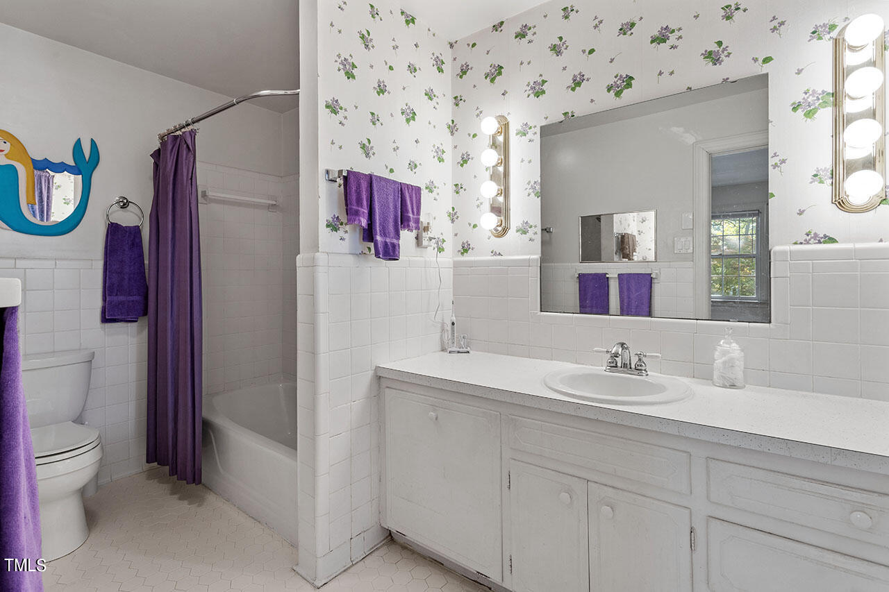 3408 Caldwell Drive Raleigh, NC 27607 - Photo 39 of 46 a bathroom with a sink and a mirror