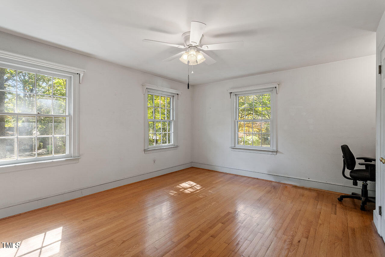 3408 Caldwell Drive Raleigh, NC 27607 - Photo 42 of 46 a view of an empty room with a window and wooden floor