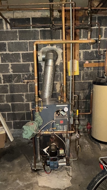 87 Ashfield Road Conway, MA 01341 - Photo 36 of 38 a room with water heater and racks
