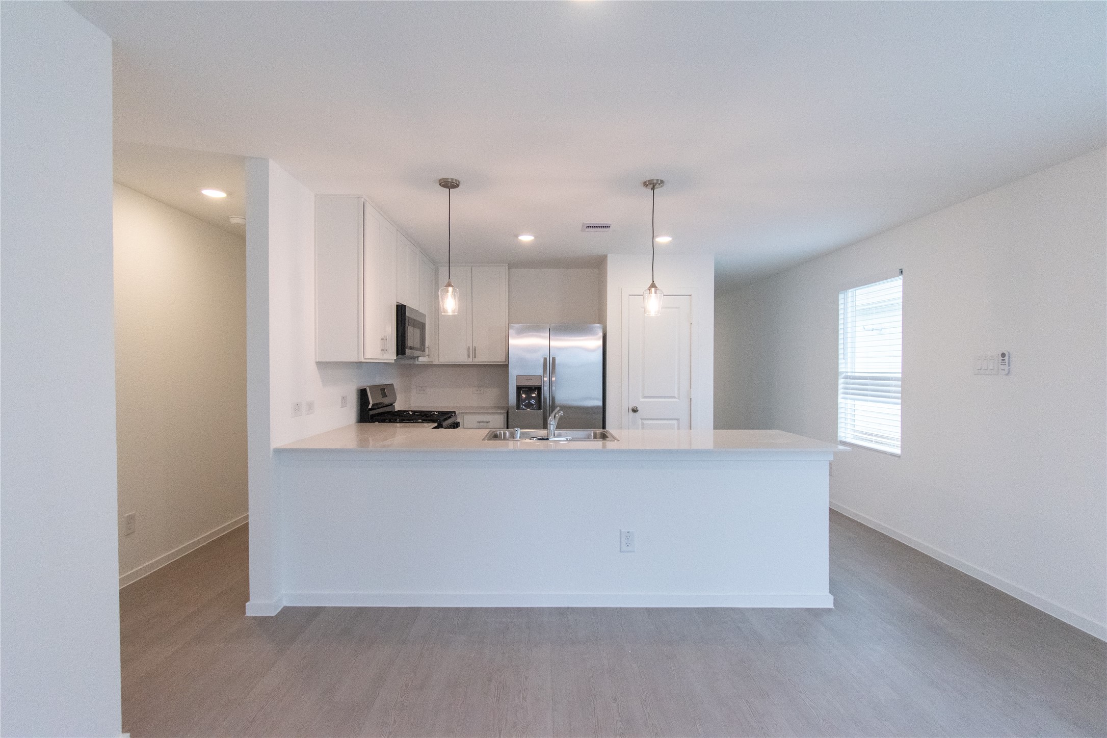 31432 Moore Road Magnolia, TX 77354 - Photo 11 of 26 a large kitchen with a large counter top stainless steel appliances and cabinets