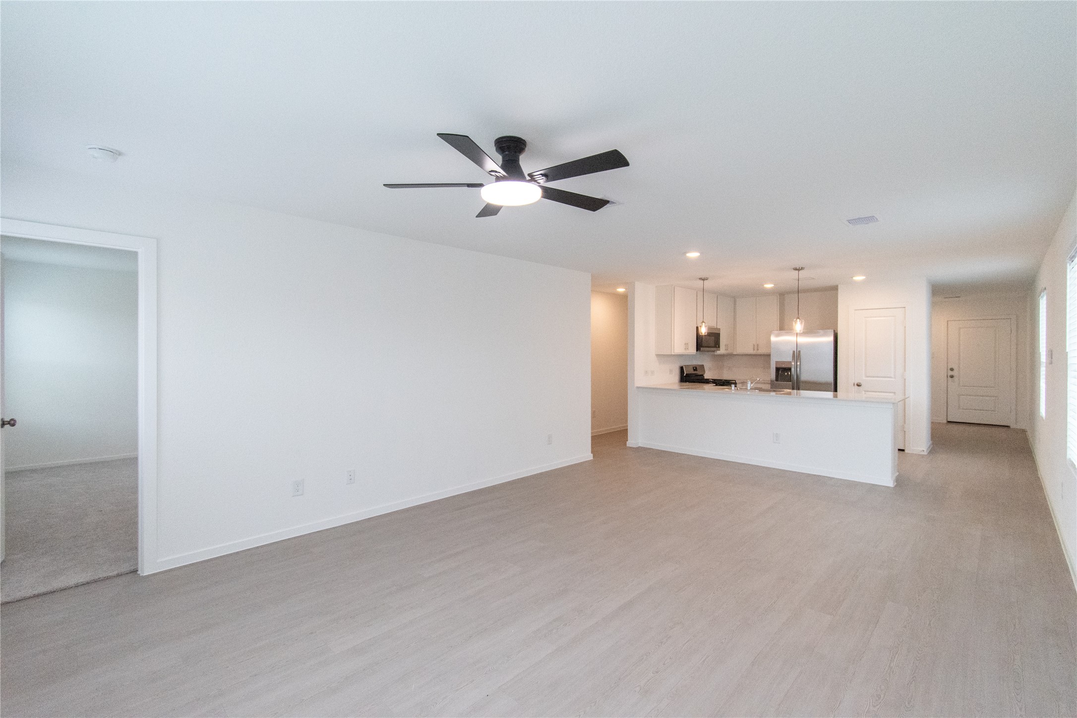 31432 Moore Road Magnolia, TX 77354 - Photo 13 of 26 a view of a kitchen with a sink and a chandelier fan