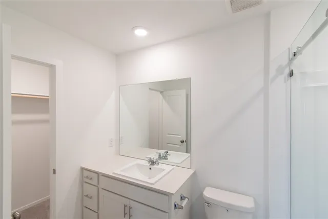 a bathroom with a sink toilet and mirror
