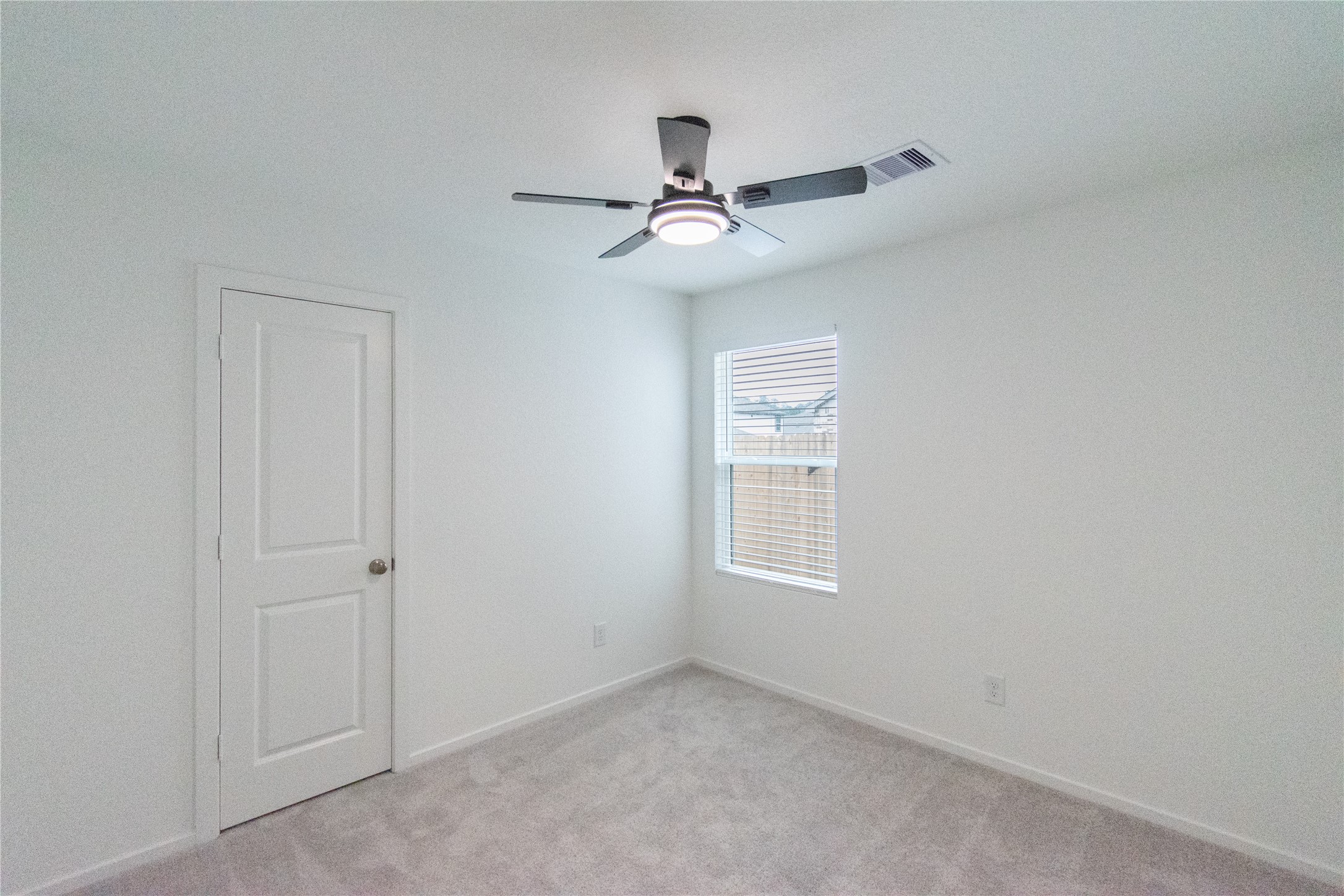 31432 Moore Road Magnolia, TX 77354 - Photo 19 of 26 an empty room with windows and fan