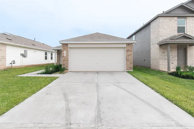 a view of a house with a yard and garage