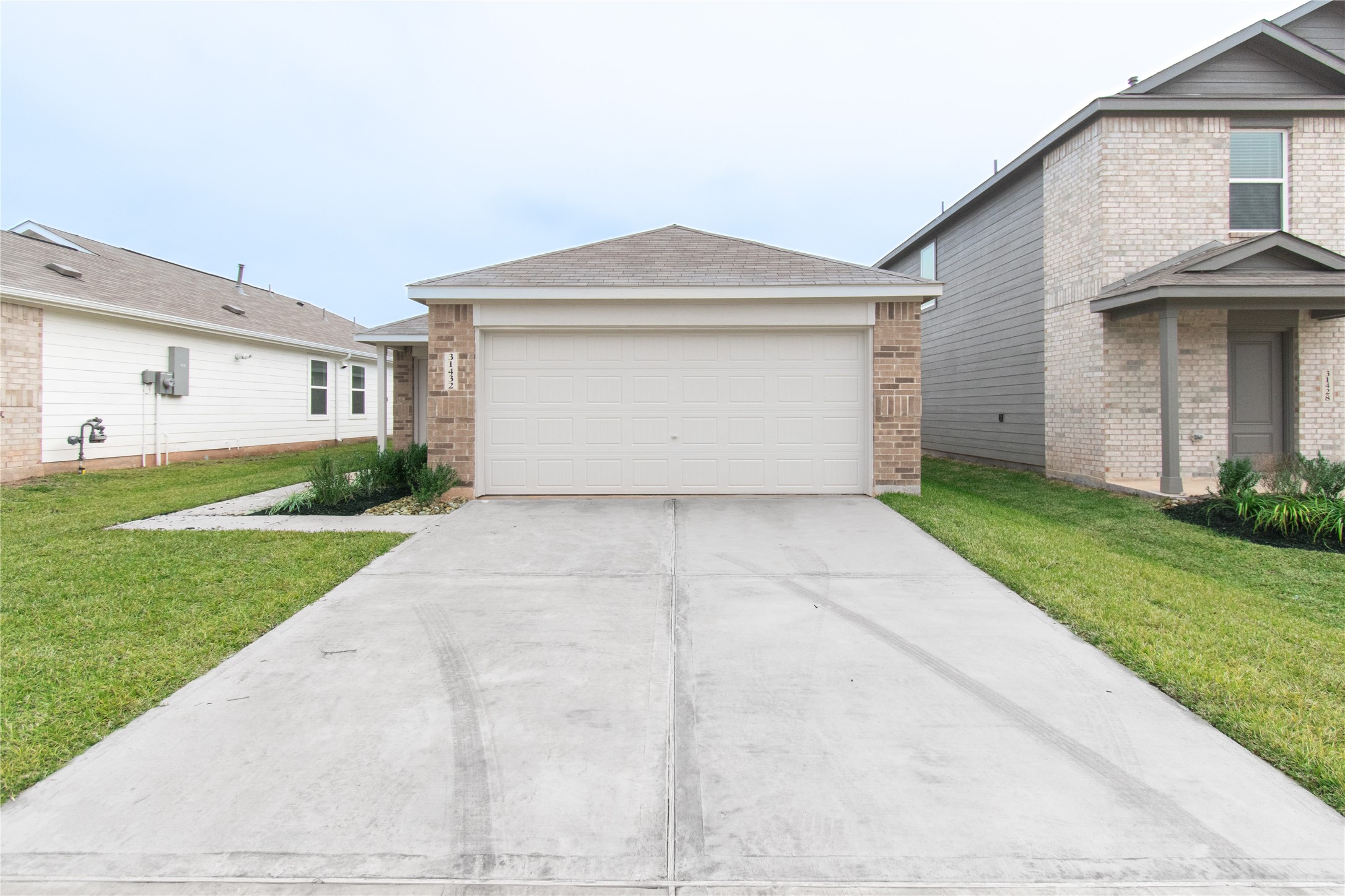 31432 Moore Road Magnolia, TX 77354 - Photo 2 of 26 a view of a house with a yard and garage