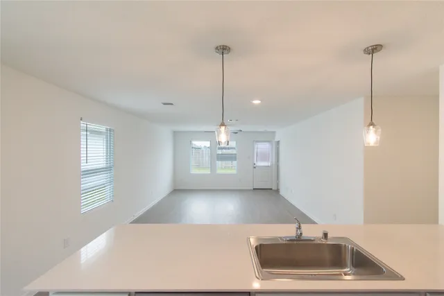 a kitchen with kitchen island a sink window and a counter top space