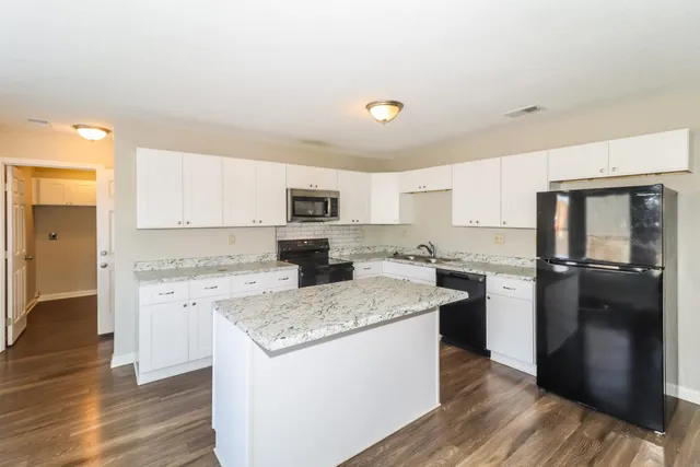 a kitchen with a refrigerator stove and sink