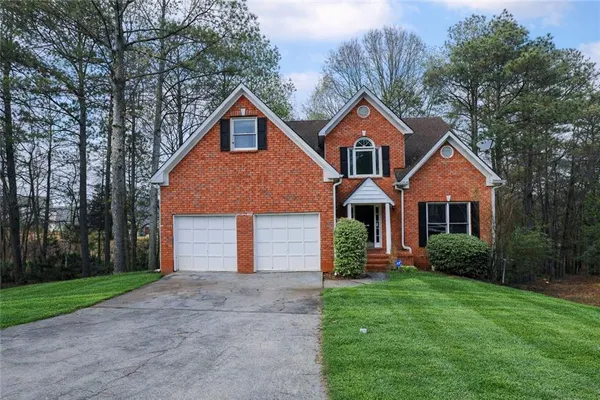 a front view of house with yard and green space