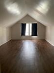 800 Travis Street, Unit ATTIC Columbus, TX 78934 - Photo 1 of 9 an empty room with wooden floor and windows