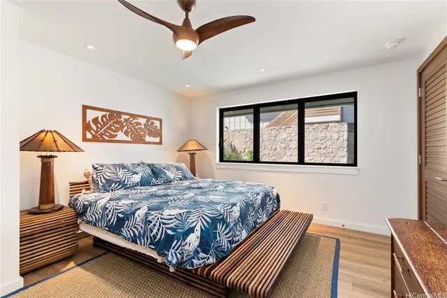 a bedroom with a large bed and a window