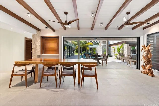 a dining room with furniture and a floor to ceiling window